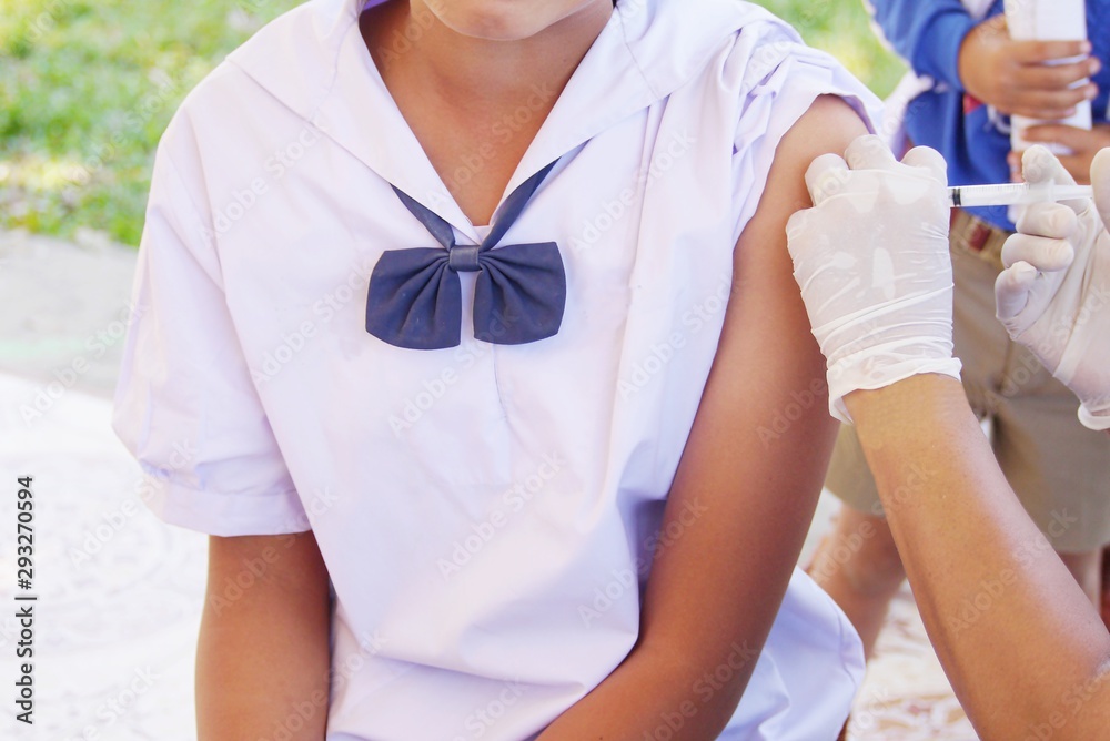Fototapeta premium The doctor vaccinated the school children .