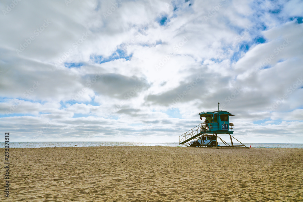 Fototapeta premium Sand Beach, Dramatic Cloudy Sky, and Lifeguard Tower