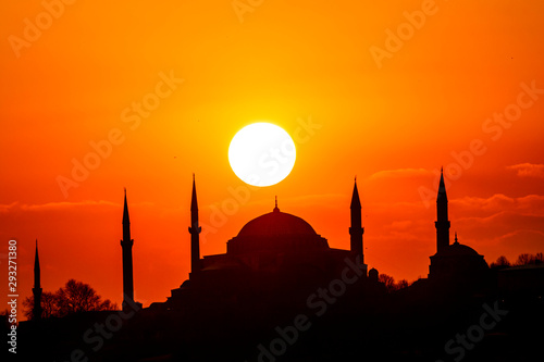 Cityscape of Istanbul with silhouettes of ancient mosques and minarets at sunset. Panoramic view, The Maiden's Tower, Galata Tower, Hagia Sophia, The Blue Mosque and Topkapı Palace in Istanbul.