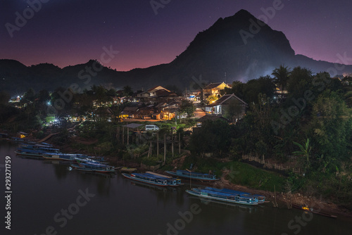 Quiet village of Nong Khiaw along the Nam Ou river and the scenic moutains around at the dusk Laos photo