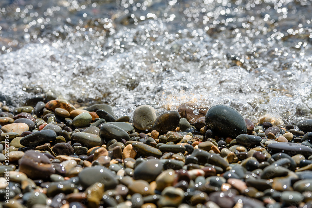 Wet pebbles and sea waves-the texture of the sea coast. Wet pebbles and sea waves-the texture of the sea coast.