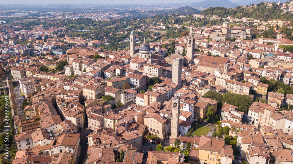Fototapeta premium Bergamo, Italy. Amazing drone aerial view of the old town. Landscape at the city center, Its historical buildings and the towers