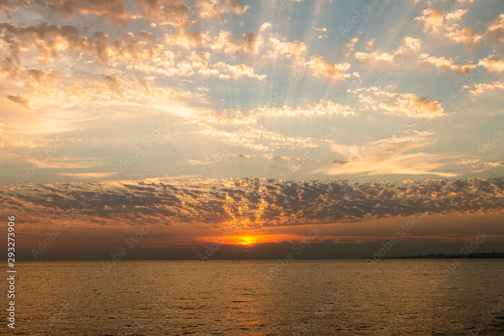 Sun rays float through the clouds at romantic sunset Sun rays float through the clouds at romantic sunset