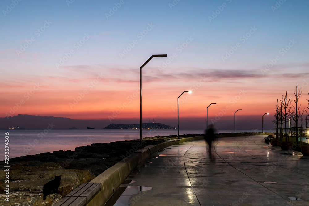 People fishing and walking at sunset on Maltepe coastal road