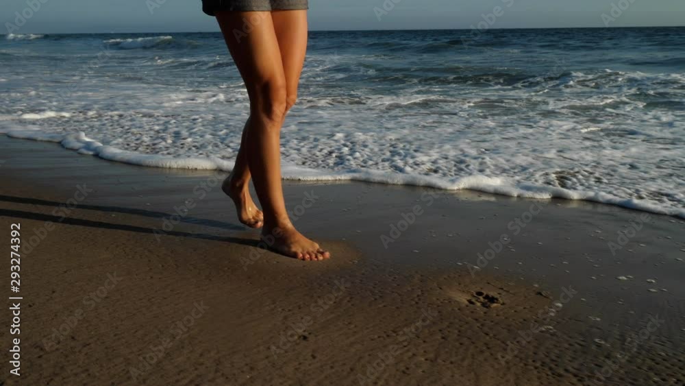 Attractive woman walking along the beach in Southern California Attractive woman walking along the beach in Southern California