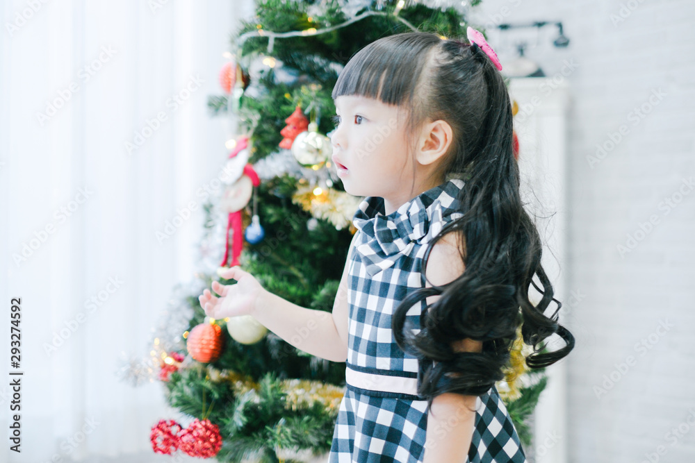 Merry christmas happy little child with beautifully decorated christmas tree holidays in home, christmas concept