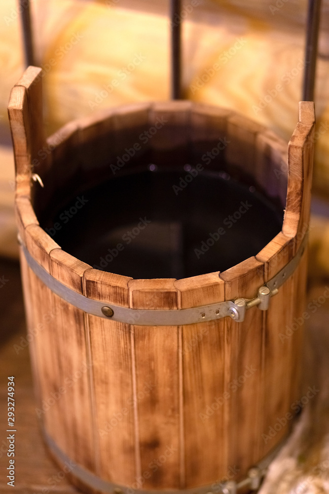 .wooden bucket with hot water from the Russian wooden hot bath .wooden bucket with hot water from the Russian wooden hot bath
