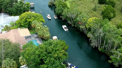 Drone following boat cruising in the beautiful water of a natural spring in Florida's nature coast photo