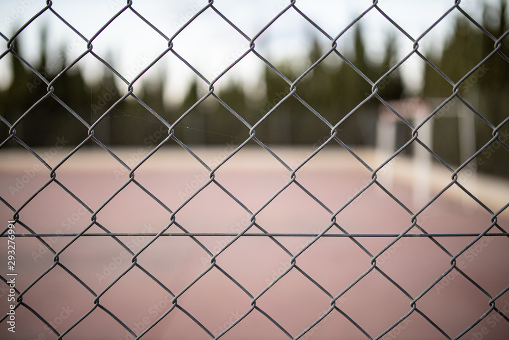 wire fence at sunset with unfocused background