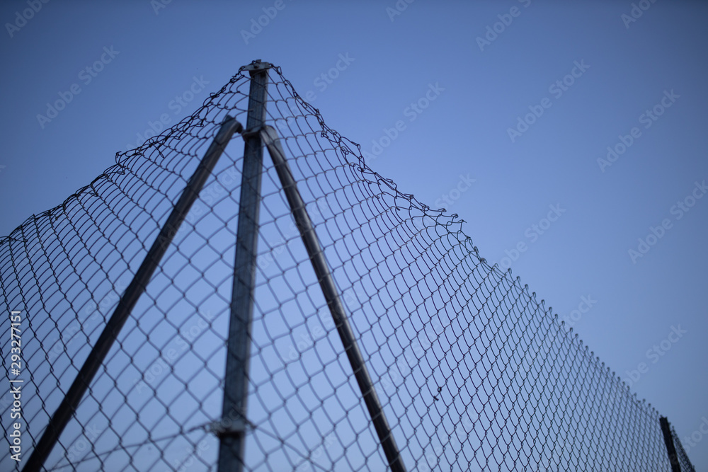 wire fence at sunset with unfocused background wire fence at sunset with unfocused background