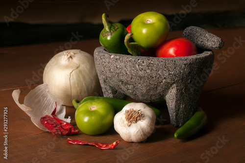 Still life photography, Mexican Molcajete with vegetables to prepare salsa photo