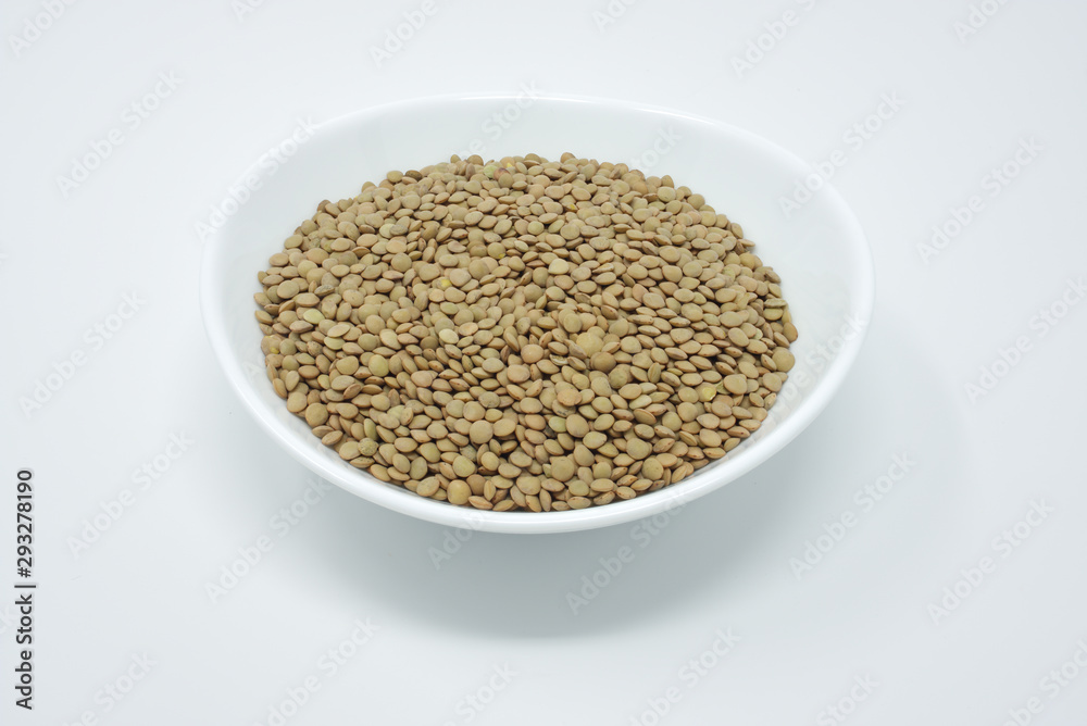 Isolated plate, full of uncooked lentil seeds. Isolated plate, full of uncooked lentil seeds.