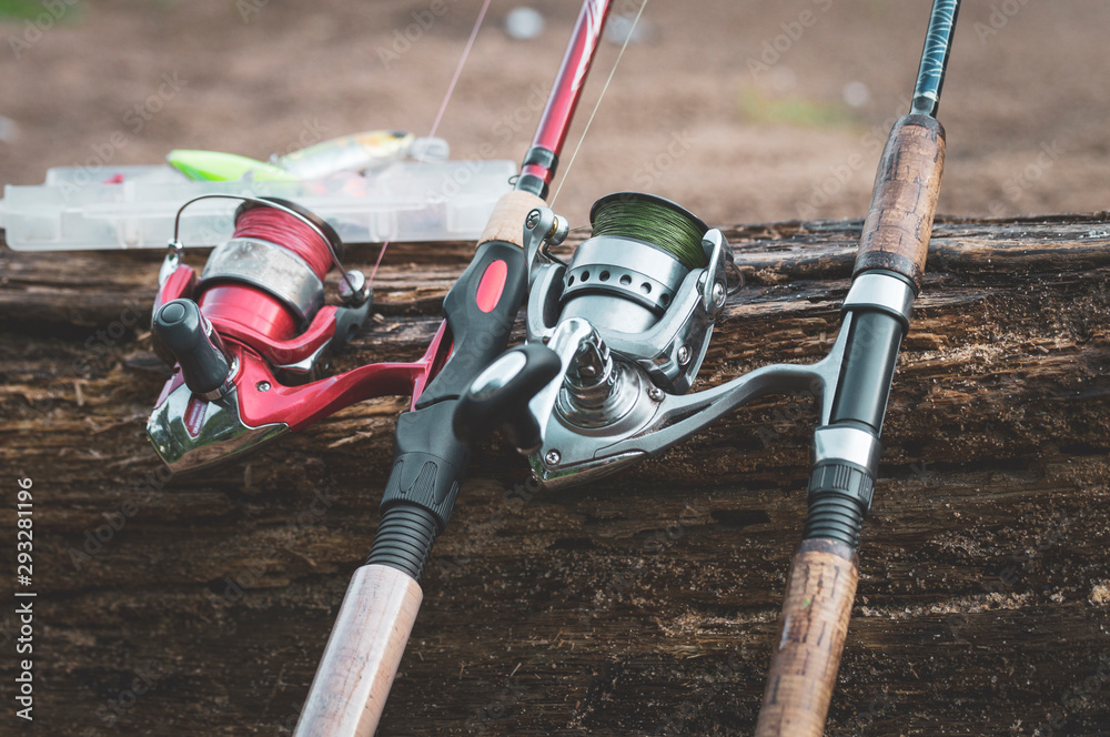 Spinning and tree background, fishing, selective focusing Spinning and tree background, fishing, selective focusing