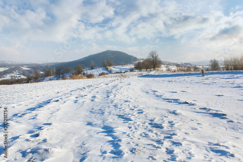 Fields and hills under the snow in winter. © agneskantaruk