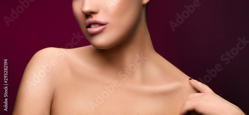 Lips, neck, shoulders, part of bauty woman face. Perfect skin, nude natural make-up. Dark red background. Facial treatment skincare health concept