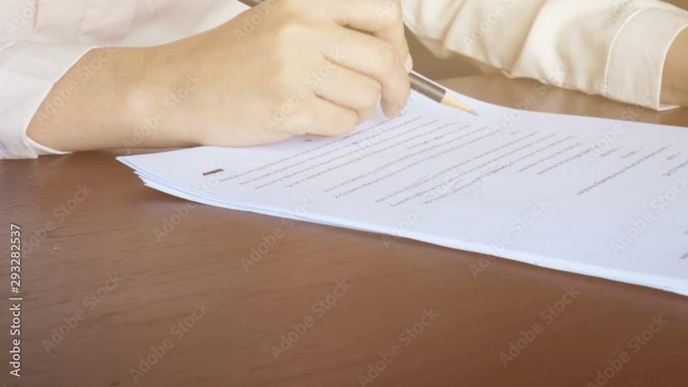 4K. woman reading on paper , flip page and use pencil to marking text on document