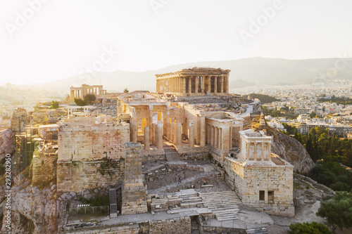 Aerial view of a slide from the drone on the panorama of residential buildings of the city of Athens, on the main symbol of ancient Greece, Acropolis at sunrise. The lights sun. World Heritage sites