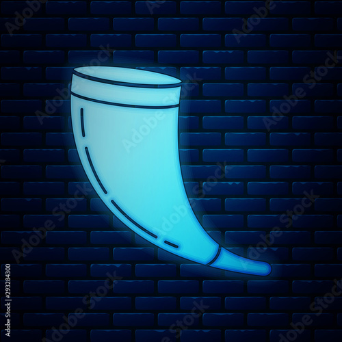 Glowing neon Traditional ram horn, shofar icon isolated on brick wall background. Rosh hashanah, jewish New Year holiday traditional symbol. Vector Illustration