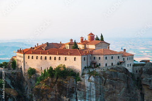 Aerial view of a slide from a drone on a panorama of a mountain range. Kalampaka city, Greece. View of the cliffs of Meteora and the monasteries of Meteora. Many ancient Orthodox monasteries