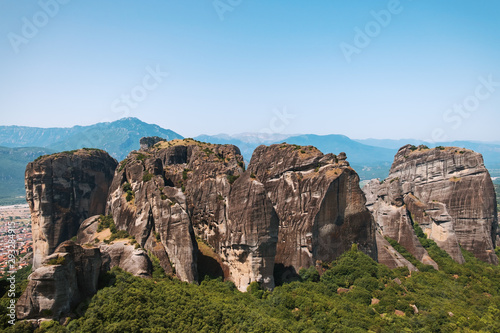 Aerial view of a slide from a drone on a panorama of a mountain range. Kalampaka city, Greece. View of the cliffs of Meteora and the monasteries of Meteora. Many ancient Orthodox monasteries