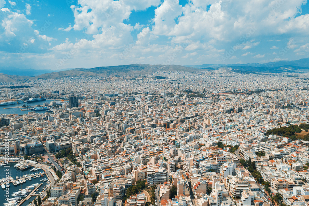 Piraeus, Greece aerial view drone on panorama of buildings of residential and administrative buildings of the city in summer on sunny day. Roof plan aerial view of the blue sea. Front view Piraeus, Greece aerial view drone on panorama of buildings of residential and administrative buildings of the city in summer on sunny day. Roof plan aerial view of the blue sea. Front view