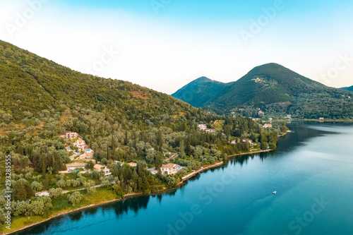 Aerial view from a drone on a panorama of the blue sea  picturesque islands and mountains in Greece  in summer on a sunny day. Beautiful coastline of the resort town. Tourism