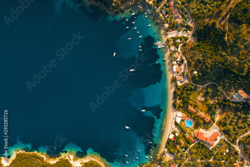 Fototapeta Naklejka Na Ścianę i Meble -  Aerial view from the drone to the panorama of the blue sea and the picturesque islands in Greece, in summer on a sunny day. Beautiful coastline of the resort town. Tourism. Family travel