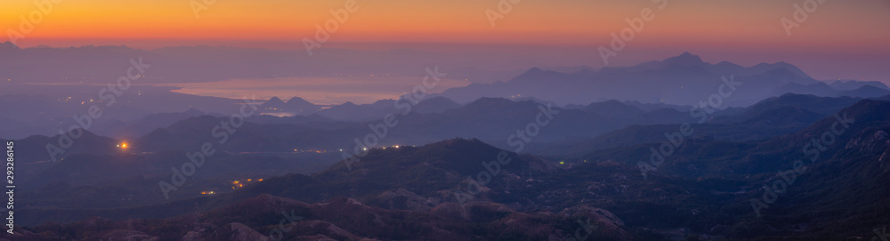 Panorama of Skadar Lake in Montenegro during sunrise on a beautiful foggy morning. Visible mountains surrounding the lake