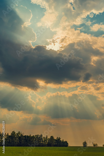 beautiful view of sun rays shining due to thunderclouds
