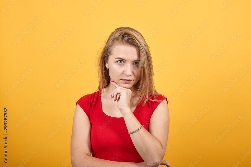 young blonde girl in red t-shirt over isolated orange background shows emotions young blonde girl in red t-shirt over isolated orange background shows emotions