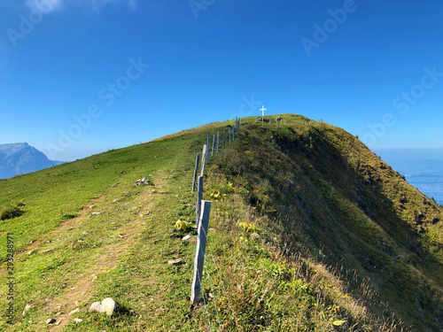 Grassy alpine mountain peak Buochserhorn above Lake Lucerne or Vierwaldstaetersee lake (Vierwaldstattersee or Vierwaldsättersee), Buochs - Canton of Nidwalden, Switzerland photo