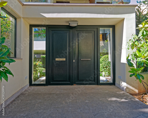 elegant apartment building entrance green metallic door, Athens Greece