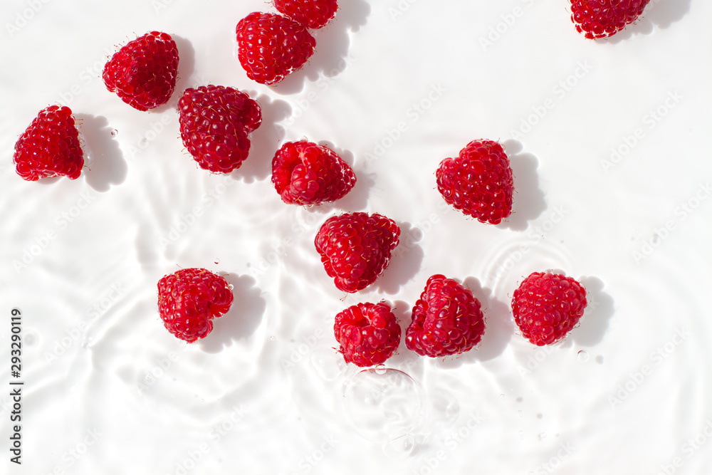 Organic raspberries in water on the white background. Top view Organic raspberries in water on the white background. Top view