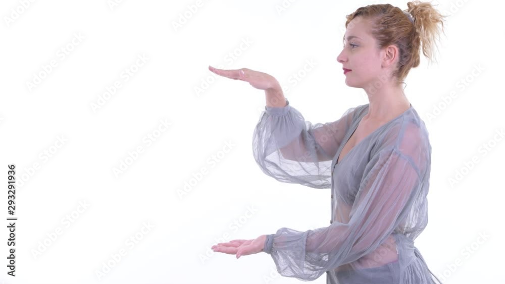 Happy beautiful blonde woman snapping fingers and showing something