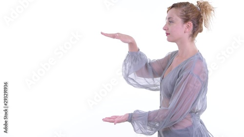 Happy beautiful blonde woman snapping fingers and showing something