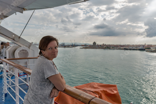 Woman travels on ferry ship. Livorno in the background, Italy. © Panama