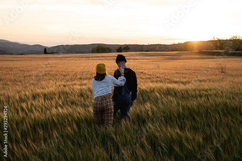 Young couple kissing and hugging at sunset .Millennial happy people concept