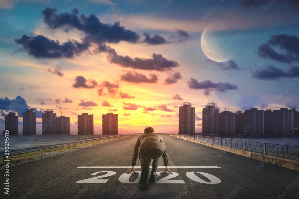 Businessman starting road to success 2020. Elements of this image furnished by NASA. - obrazy, fototapety, plakaty 
