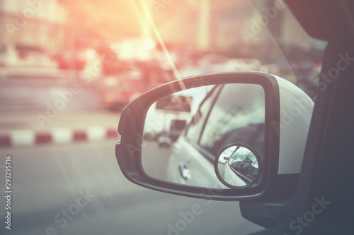 Side rear-view in left mirror on a car. vintage tone