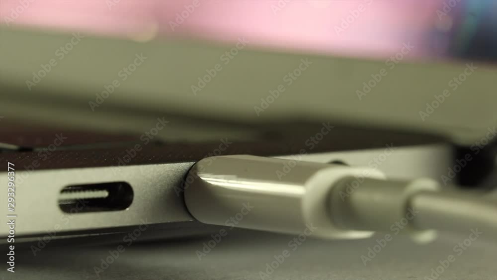 Connect white USB - C cable, charge silver computer and transfer data. Connect white USB - C cable, charge silver computer and transfer data.