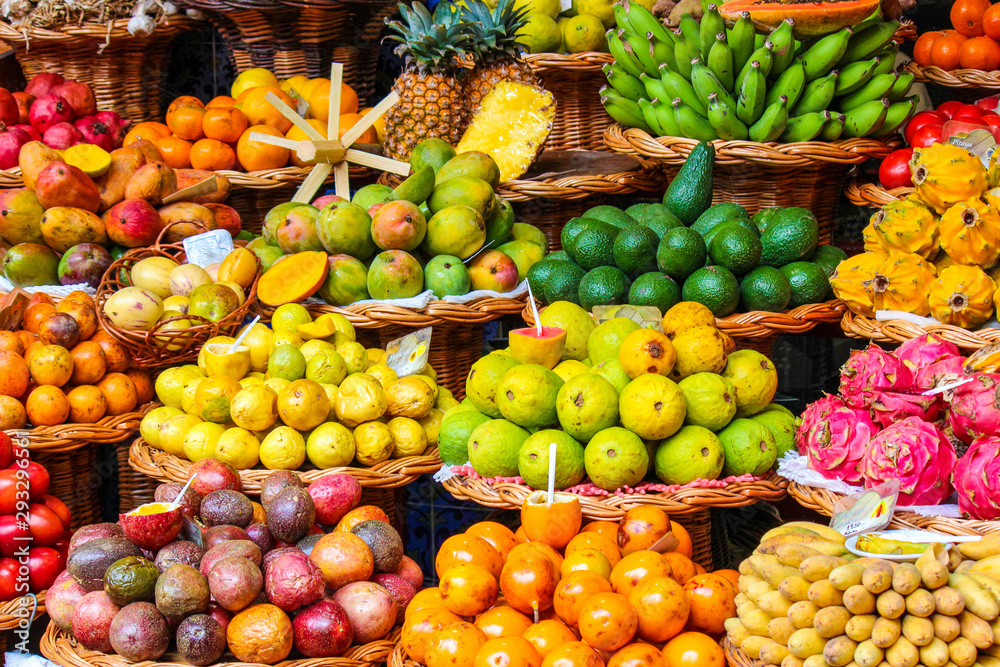 Tropical fruits on the famous market in Funchal, Madeira Island, Portugal. Exotic fruit. Banana, mango, passion fruit or avocado. Colorful food, healthy lifestyle Tropical fruits on the famous market in Funchal, Madeira Island, Portugal. Exotic fruit. Banana, mango, passion fruit or avocado. Colorful food, healthy lifestyle