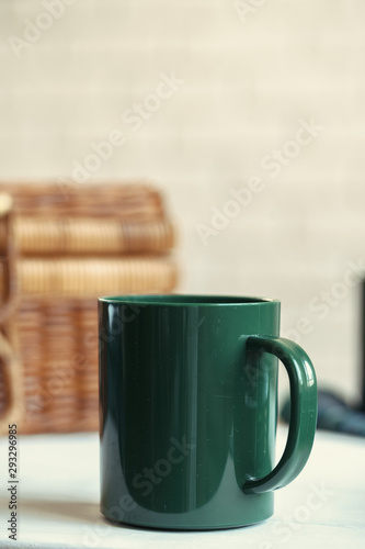 Fototapeta Naklejka Na Ścianę i Meble -  Green plastic kitchenware on a table close up