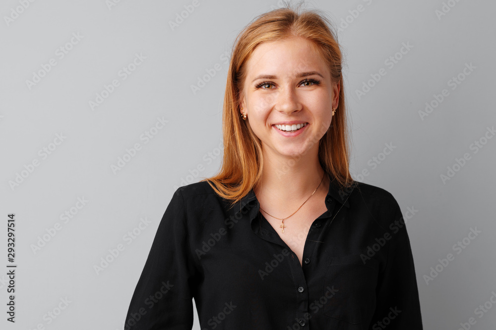 Beautiful young woman teenager posing over a grey background Beautiful young woman teenager posing over a grey background