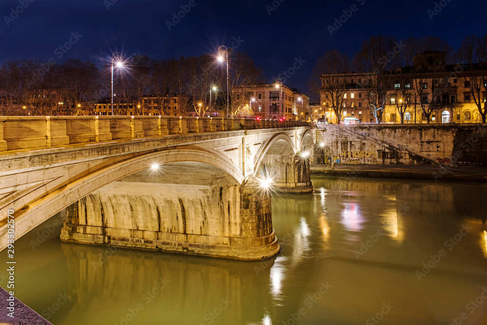 Rome, Italy, February 20, 2017 - view of Rome and Vatican, Italy. Tiber River with bridges in Rome. Beautiful scenic panorama of Rome city. Night photo