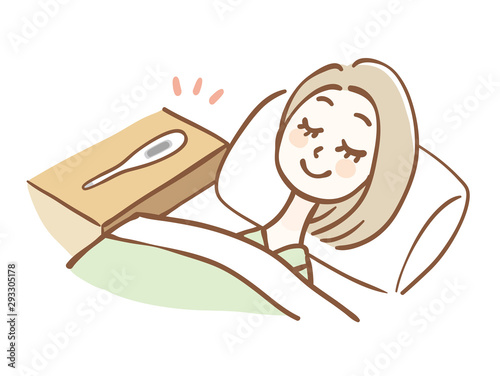 枕元に体温計を置いて眠る女性