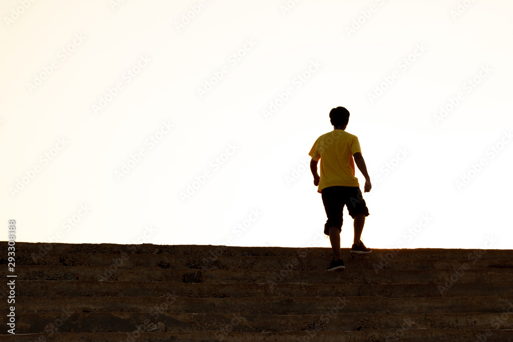 The young man on top of the stairs going to the sunset sky, Ambitions concept and Successful. The young man on top of the stairs going to the sunset sky, Ambitions concept and Successful.