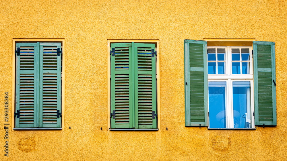Windows with the green shutters and wooden stork