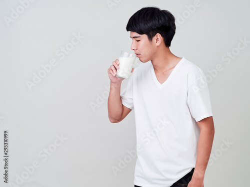 Young man holding glass of fresh milk