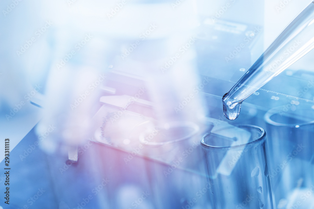 microscope with dropping liquid to test tubes, science laboratory research and development concept microscope with dropping liquid to test tubes, science laboratory research and development concept