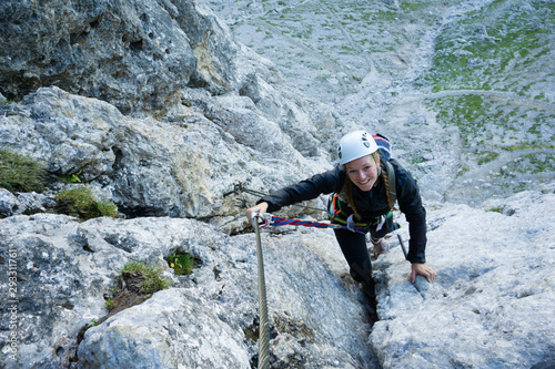attractive female mountain climber in the Dolomites on a Via Ferrata